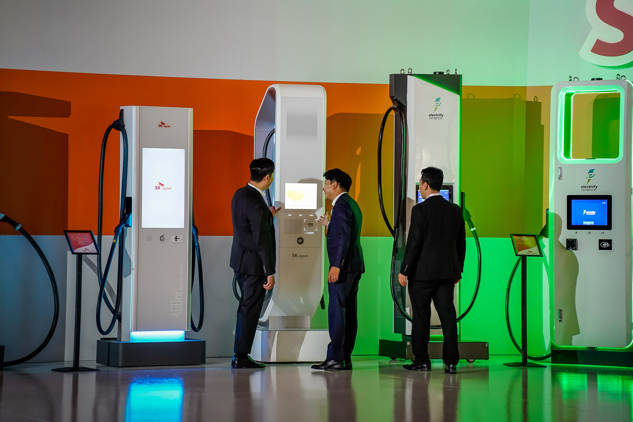 Attendees get an up-close look at ultra-fast EV chargers at the grand opening of the SK Signet manufacturing facility in Plano, Texas. The new plant will have the capacity to make more than 10,000 ultra-fast chargers a year. Photo: PRNewsfoto/SK Group