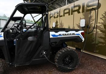 An all-electric Polaris Ranger XP Kinetic off-road vehicle charging at one of the four new off-road charging stations in Michigan's Upper Peninsula. Photo: Daniel Boczarski/Getty Images for Polaris