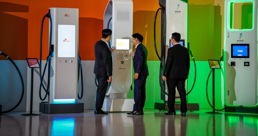 Attendees get an up-close look at ultra-fast EV chargers at the grand opening of the SK Signet manufacturing facility in Plano, Texas. The new plant will have the capacity to make more than 10,000 ultra-fast chargers a year. Photo: PRNewsfoto/SK Group