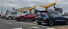 The new charging hub features Fastned’s illuminated yellow wings, which help EV drivers locate the site easily. Photo: Fastned